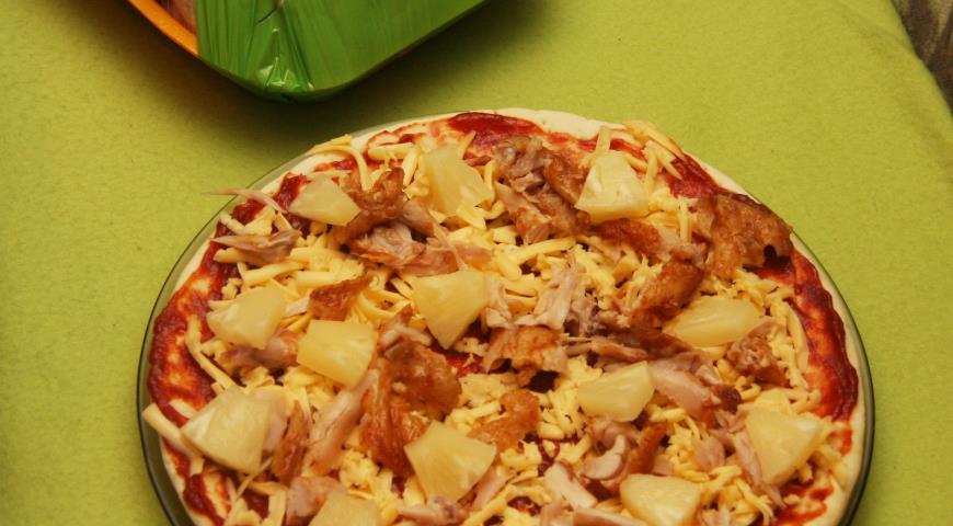 Выложить на пиццу нарезанный на кусочки ананас