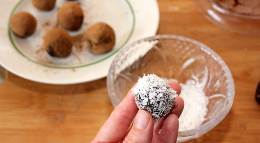 Готовые конфеты из фиников посыпаем кокосовой стружкой